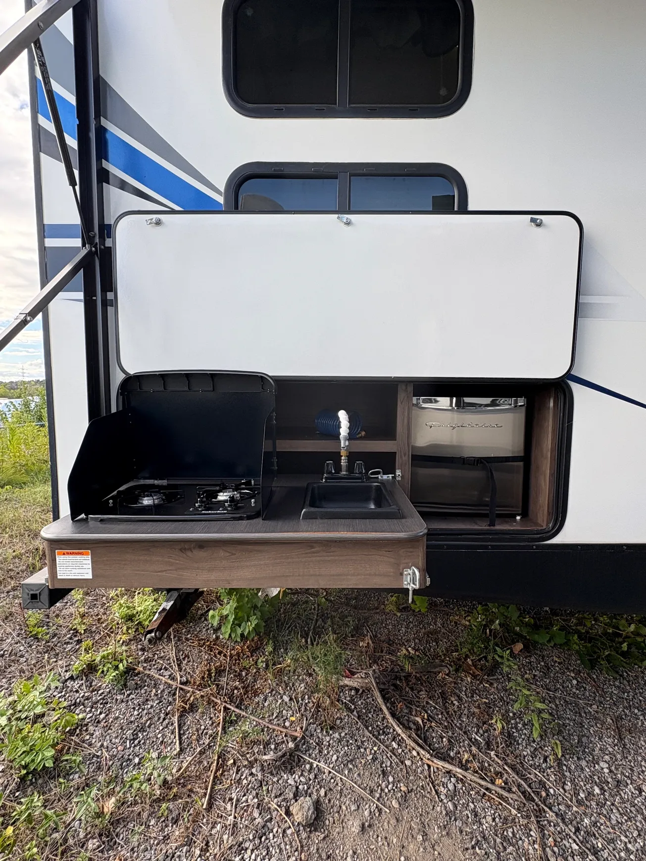 Camper kitchen open for outdoor cooking