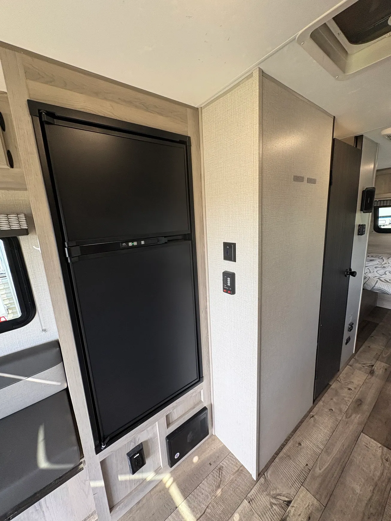 RV interior with black fridge