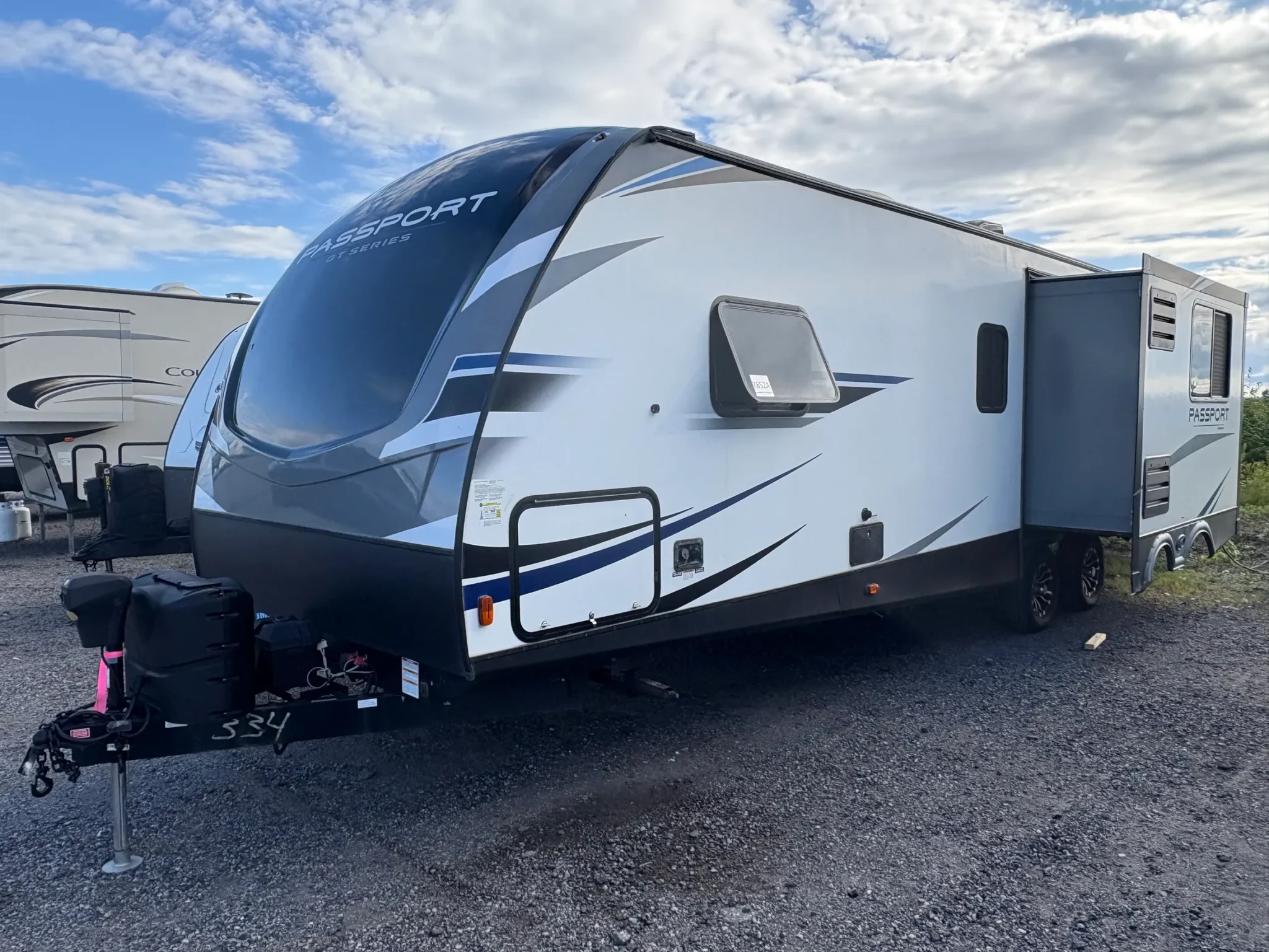 White and black recreational vehicle outdoors.